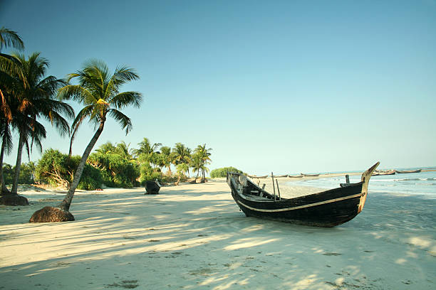 Boat resting on a beach on St. Martins Island, Bangladesh